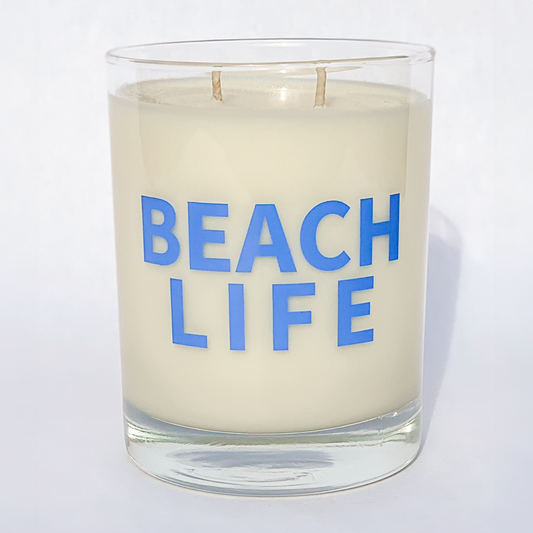 Double wicked soy candle in a 13.5 oz tumbler with "Beach Life" printed on the face.. SEO Text – Drinking glass, soy wax candle, Christmas Candle, hand poured, small batch, scented candle, Woman Owned, local candle, Housewarming present, gives back, charity, community candle, becomes a cocktail glass, closing gift.