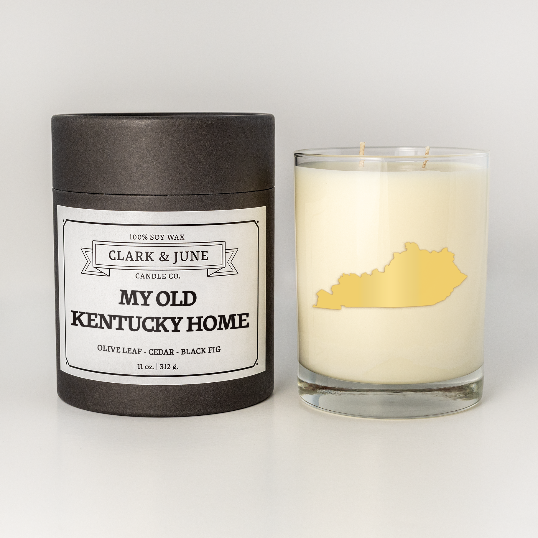 Double wicked soy candle in a 13.5 oz tumbler with the state of Kentucky printed in 22k gold foil on the face. Black cylinder packaging with “My Old Kentucky Home” on the label. SEO Text – Drinking glass, soy wax candle, Alabama candle, hand poured, small batch, scented candle, Woman Owned, local candle, Housewarming present, gives back, charity, community candle, becomes a cocktail glass, closing gift.