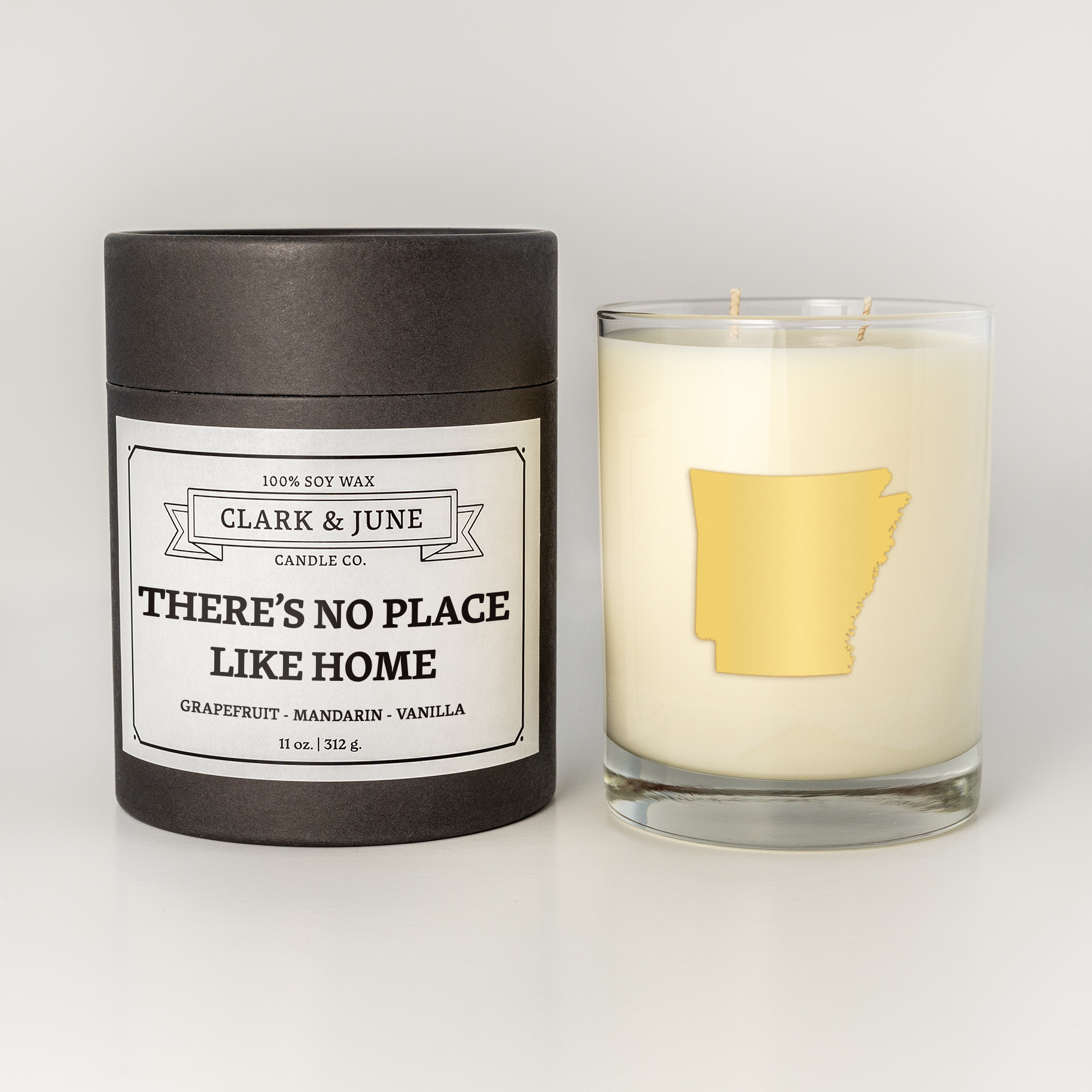 Double wicked soy candle in a 13.5 oz tumbler with the state of Arkansas printed in 22k gold foil on the face. Black cylinder packaging with “There’s No Place Like Home” on the label.