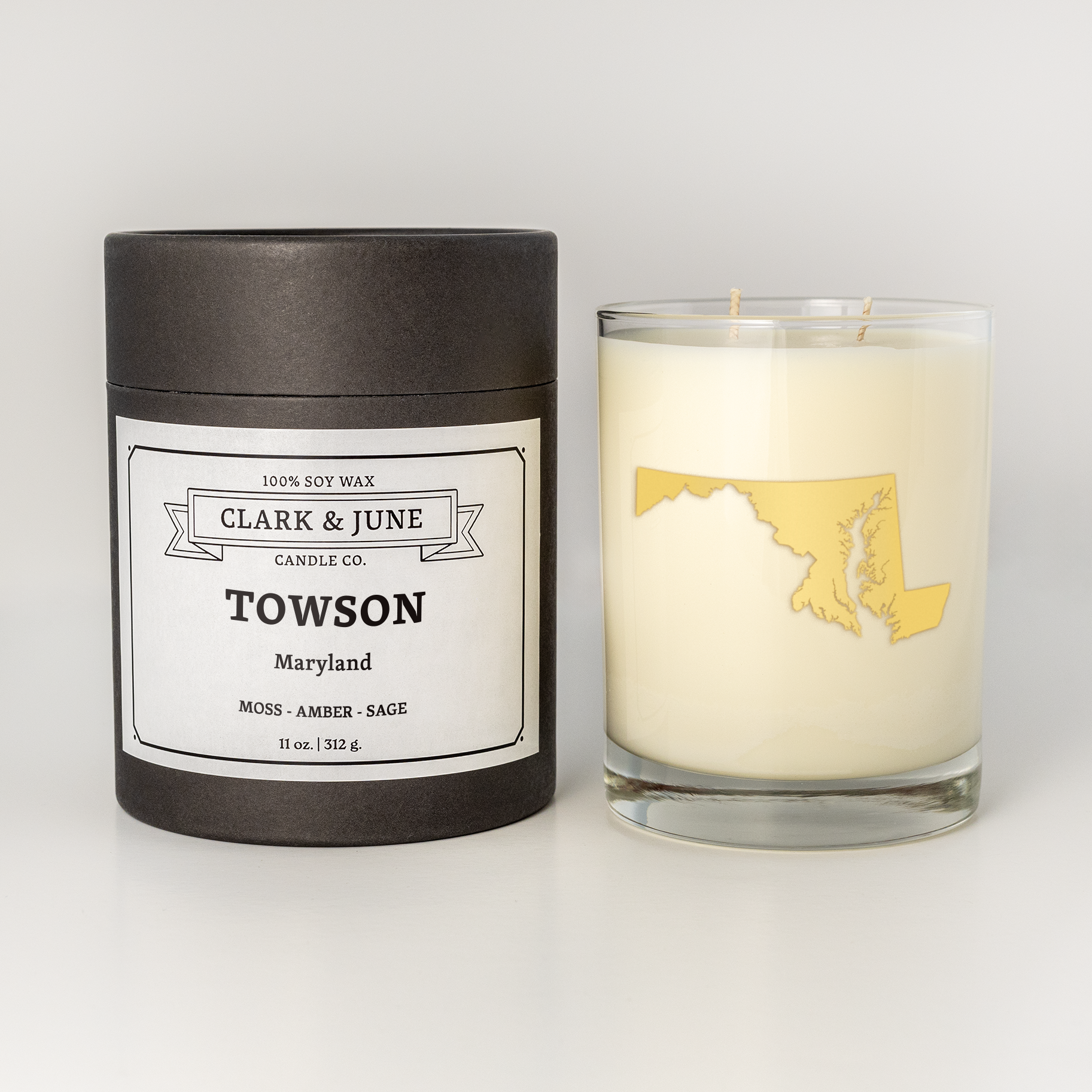 Double wicked soy candle in a 13.5 oz tumbler with the state of  Maryland printed in 22k gold foil on the face. Black cylinder packaging with Towson  on the label. SEO Text – Drinking glass, soy wax candle, Christmas Candle, hand poured, small batch, scented candle, Woman Owned, local candle, Housewarming present, gives back, charity, community candle, becomes a cocktail glass, closing gift.