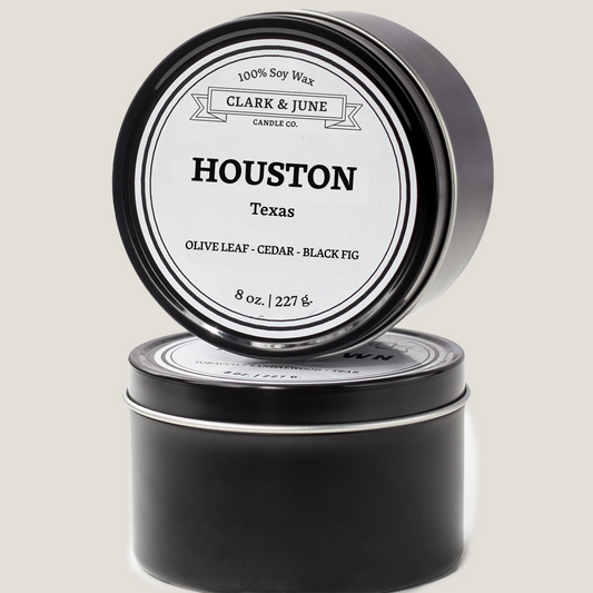 Single wicked 8oz candle in a black finish with Houston  on the label. SEO Text –soy wax candle, Texas candle, hand poured, small batch, scented candle, Woman Owned, local candle, Housewarming present, gives back, charity, community candle, closing gift.
