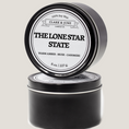 Load image into Gallery viewer, Single wicked 8oz candle in a black finish with The Lone Star State  on the label. SEO Text –soy wax candle, Texas candle, hand poured, small batch, scented candle, Woman Owned, local candle, Housewarming present, gives back, charity, community candle, closing gift.