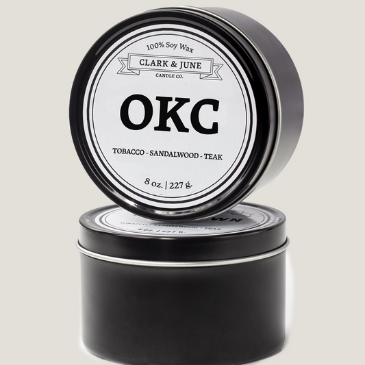 Single wicked 8oz candle in a black finish with OKC on the label. SEO Text –soy wax candle, Oklahoma candle, hand poured, small batch, scented candle, Woman Owned, local candle, Housewarming present, gives back, charity, community candle, closing gift.