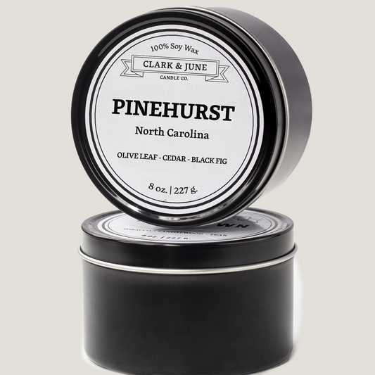 Single wicked 8oz candle in a black finish with Pinehurst  on the label. SEO Text –soy wax candle, North Carolina candle, hand poured, small batch, scented candle, Woman Owned, local candle, Housewarming present, gives back, charity, community candle, closing gift.