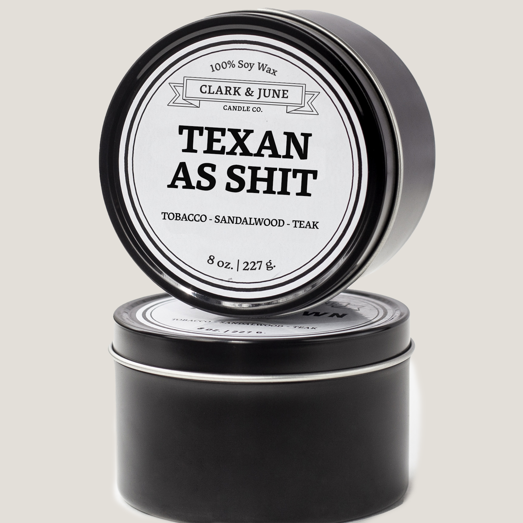 Single wicked 8oz candle in a black finish with Texan as Shit  on the label. SEO Text –soy wax candle, Texas candle, hand poured, small batch, scented candle, Woman Owned, local candle, Housewarming present, gives back, charity, community candle, closing gift.
