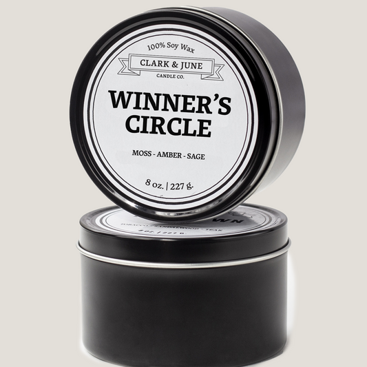 Single wicked 8oz candle in a black finish with Winner's Circle on the label. SEO Text –soy wax candle, Kentucky candle, hand poured, small batch, scented candle, Woman Owned, local candle, Housewarming present, gives back, charity, community candle, closing gift.