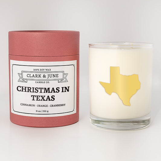 Double wicked soy candle in a 13.5 oz tumbler with the state of  Texas printed in 22k gold foil on the face. Red cylinder packaging with Christmas in Texas on the label. SEO Text – Drinking glass, soy wax candle, Christmas Candle, hand poured, small batch, scented candle, Woman Owned, local candle, Housewarming present, gives back, charity, community candle, becomes a cocktail glass, closing gift.