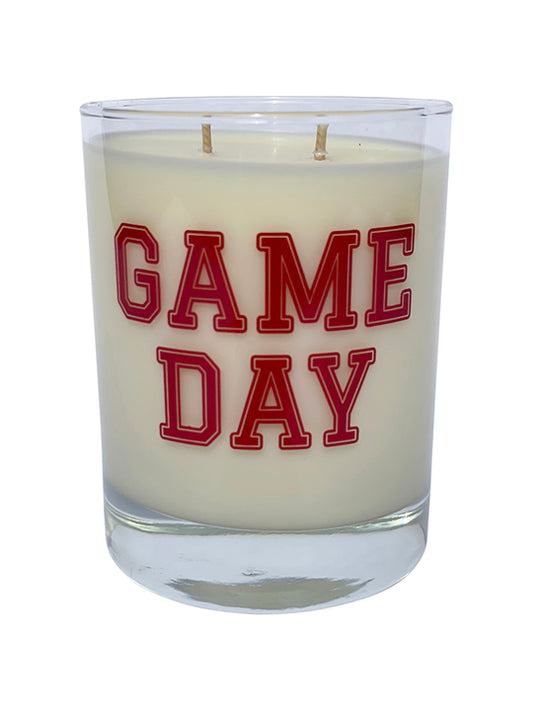 Double wicked soy candle in a 13.5 oz tumbler with the Game Day printed on the face of the vessel in Red. SEO Text – Drinking glass, soy wax candle, Football, Tailgate, hand poured, small batch, scented candle, Woman Owned, local candle, Housewarming present, gives back, charity, community candle, becomes a cocktail glass, closing gift.