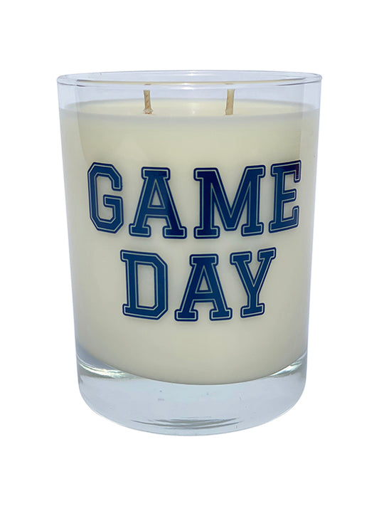 Double wicked soy candle in a 13.5 oz tumbler with the Game Day printed on the face of the vessel in Blue. SEO Text – Drinking glass, soy wax candle, Football, Tailgate, hand poured, small batch, scented candle, Woman Owned, local candle, Housewarming present, gives back, charity, community candle, becomes a cocktail glass, closing gift.