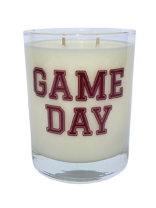 Double wicked soy candle in a 13.5 oz tumbler with the Game Day printed on the face of the vessel in Maroon. SEO Text – Drinking glass, soy wax candle, Football, Tailgate, hand poured, small batch, scented candle, Woman Owned, local candle, Housewarming present, gives back, charity, community candle, becomes a cocktail glass, closing gift.