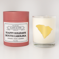 Load image into Gallery viewer, Double wicked soy candle in a 13.5 oz tumbler with the state of  South Carolina printed in 22k gold foil on the face. Red cylinder packaging with Happy Holidays South Carolina on the label. SEO Text – Drinking glass, soy wax candle, Christmas Candle, hand poured, small batch, scented candle, Woman Owned, local candle, Housewarming present, gives back, charity, community candle, becomes a cocktail glass, closing gift.