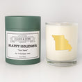 Load image into Gallery viewer, Double wicked soy candle in a 13.5 oz tumbler with the state of   Missouri printed in 22k gold foil on the face. Green cylinder packaging with Happy Holidays in "Your Town" on the label. SEO Text – Drinking glass, soy wax candle, Christmas Candle, hand poured, small batch, scented candle, Woman Owned, local candle, Housewarming present, gives back, charity, community candle, becomes a cocktail glass, closing gift.