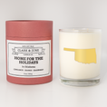 Load image into Gallery viewer, Double wicked soy candle in a 13.5 oz tumbler with the state of  Oklahoma printed in 22k gold foil on the face. Red cylinder packaging with Home for the Holidays  Oklahoma on the label. SEO Text – Drinking glass, soy wax candle, Christmas Candle, hand poured, small batch, scented candle, Woman Owned, local candle, Housewarming present, gives back, charity, community candle, becomes a cocktail glass, closing gift.
