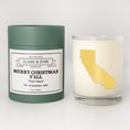 Load image into Gallery viewer, Double wicked soy candle in a 13.5 oz tumbler with the state of California printed in 22k gold foil on the face. Green cylinder packaging with Merry Christmas Y'All "Your Town" on the label. SEO Text – Drinking glass, soy wax candle, Christmas Candle, hand poured, small batch, scented candle, Woman Owned, local candle, Housewarming present, gives back, charity, community candle, becomes a cocktail glass, closing gift.