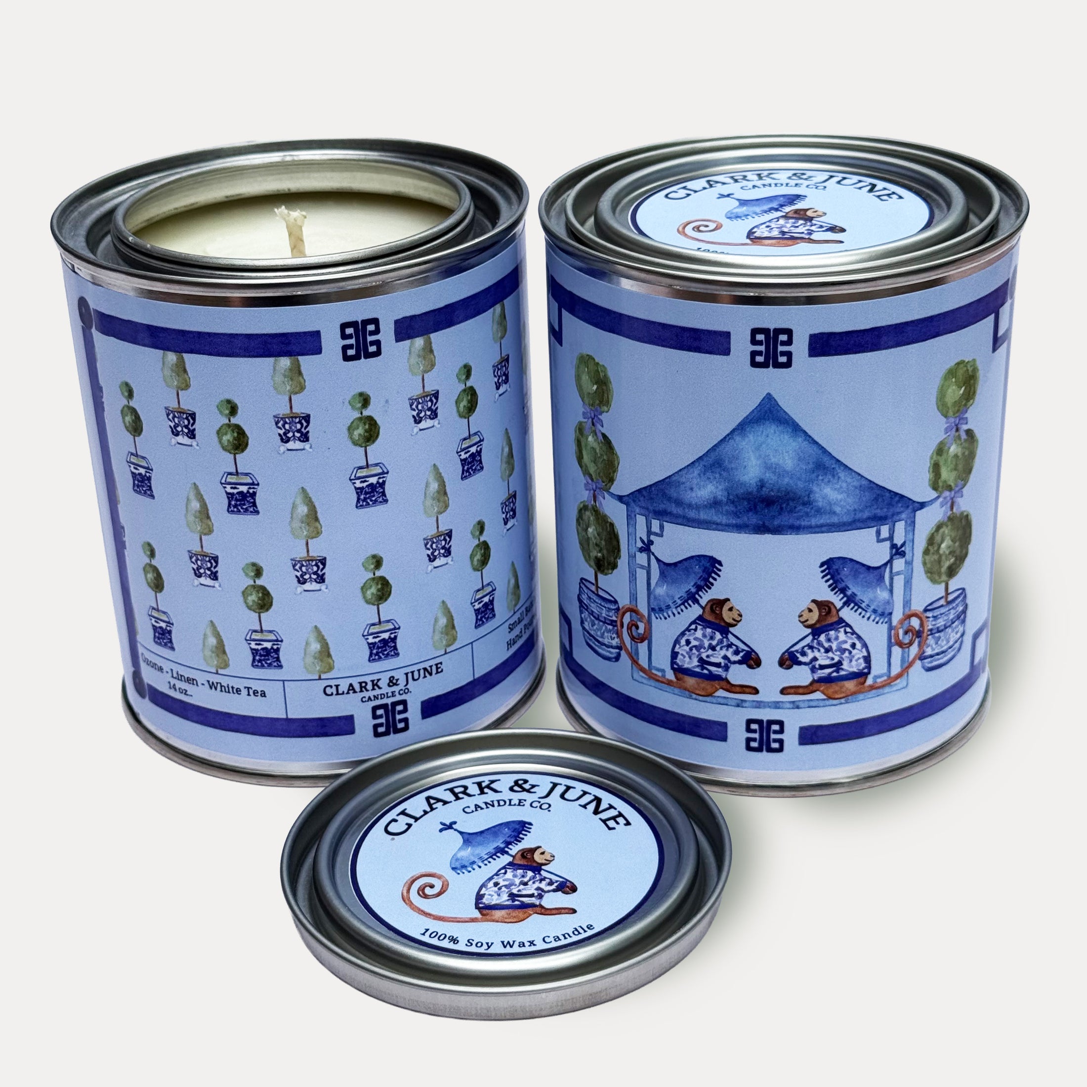 14oz Monkey Tea Time design soy wax candle in a pint sized paint can made by Clark & June Candle Co. The candle is wrapped with a blue label showing a repeating chinoiserie topiary design of the back and two monkeys sitting under a pagoda with umbrellas. The scent is Ozone – Linen – White Tea and was hand poured in small batches. 
Monkey Candle, Scented Candle, Paint Can Candle. Single Cotton Wick