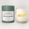 Load image into Gallery viewer, Double wicked soy candle in a 13.5 oz tumbler with the state of Tennesseeprinted in 22k gold foil on the face. Green cylinder packaging with Naughty or Nice in "Your Town" on the label. SEO Text – Drinking glass, soy wax candle, Christmas Candle, hand poured, small batch, scented candle, Woman Owned, local candle, Housewarming present, gives back, charity, community candle, becomes a cocktail glass, closing gift.