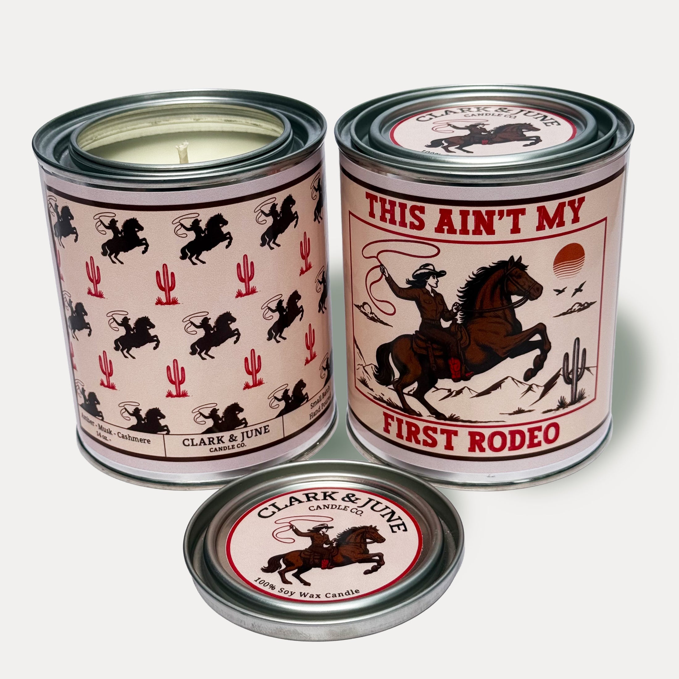 14oz Cowgirl Rodeo design soy wax candle in a pint sized paint can made by Clark & June Candle Co. The candle is wrapped with a brown and tan label with cowgirls and cacti in a repeating pattern on the back and a lasso wielding cowgirl on a horse with the phrase “This ain’t my first rodeo” on the front. The scent is Amber – Musk - Cashmere and was hand poured in small batches. 
Scented Candle, Paint Can Candle. Single Cotton Wick, Western, Rodeo Core