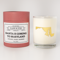 Load image into Gallery viewer, Double wicked soy candle in a 13.5 oz tumbler with the state of  Maryland printed in 22k gold foil on the face. Red cylinder packaging with Santa is Coming to Maryland on the label. SEO Text – Drinking glass, soy wax candle, Christmas Candle, hand poured, small batch, scented candle, Woman Owned, local candle, Housewarming present, gives back, charity, community candle, becomes a cocktail glass, closing gift.
