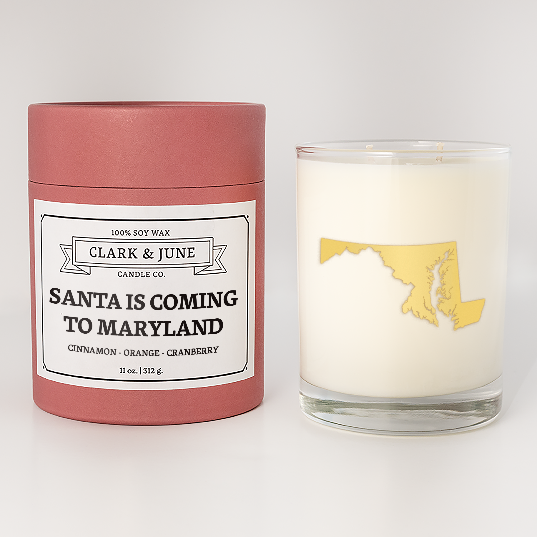 Double wicked soy candle in a 13.5 oz tumbler with the state of  Maryland printed in 22k gold foil on the face. Red cylinder packaging with Santa is Coming to Maryland on the label. SEO Text – Drinking glass, soy wax candle, Christmas Candle, hand poured, small batch, scented candle, Woman Owned, local candle, Housewarming present, gives back, charity, community candle, becomes a cocktail glass, closing gift.