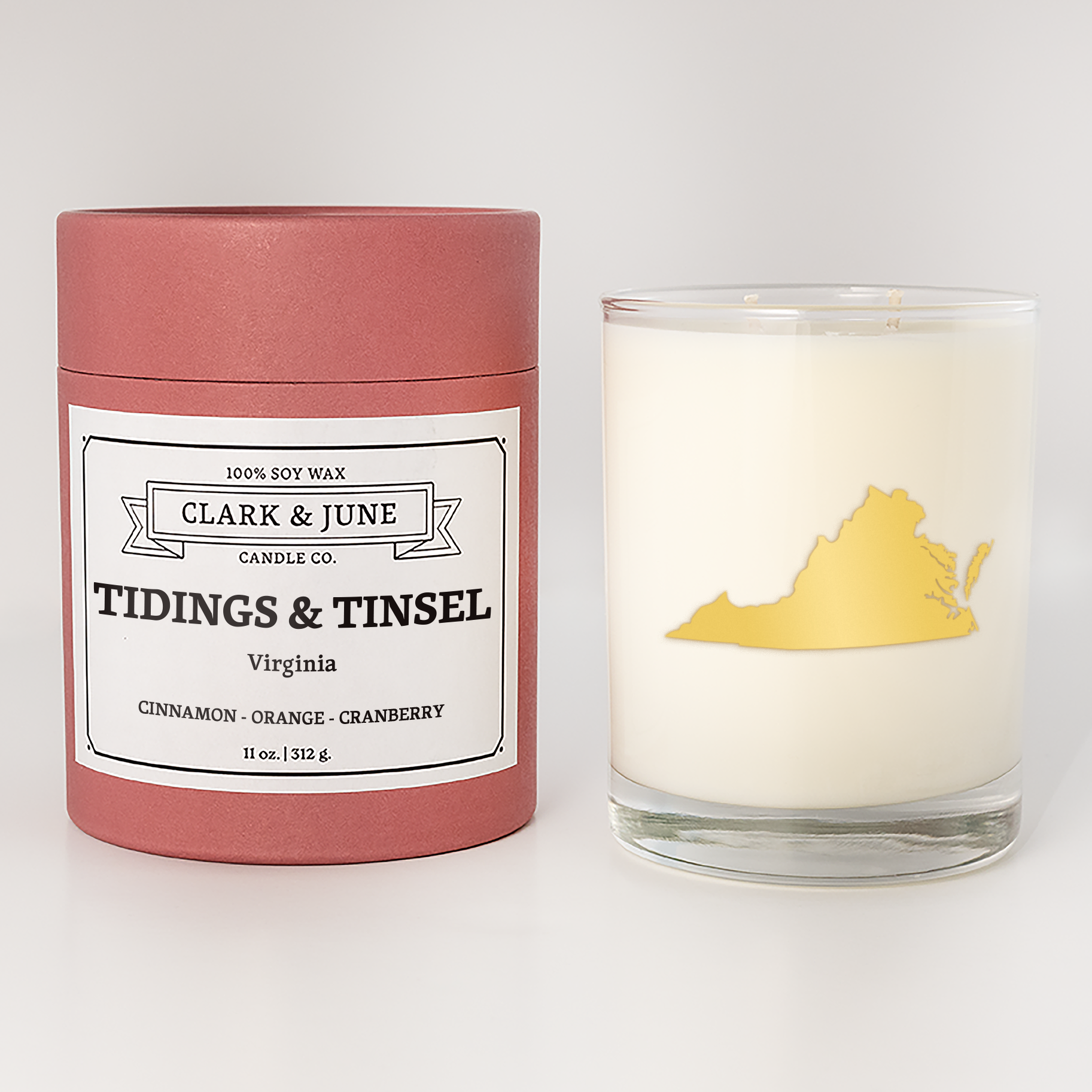 Double wicked soy candle in a 13.5 oz tumbler with the state of  Virginia printed in 22k gold foil on the face. Red cylinder packaging with Tidings & Tinsel  Virginia on the label. SEO Text – Drinking glass, soy wax candle, Christmas Candle, hand poured, small batch, scented candle, Woman Owned, local candle, Housewarming present, gives back, charity, community candle, becomes a cocktail glass, closing gift.