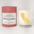 Load image into Gallery viewer, Double wicked soy candle in a 13.5 oz tumbler with the state of California printed in 22k gold foil on the face. Red cylinder packaging with Tidings & Tinsel California on the label. SEO Text – Drinking glass, soy wax candle, Christmas Candle, hand poured, small batch, scented candle, Woman Owned, local candle, Housewarming present, gives back, charity, community candle, becomes a cocktail glass, closing gift.