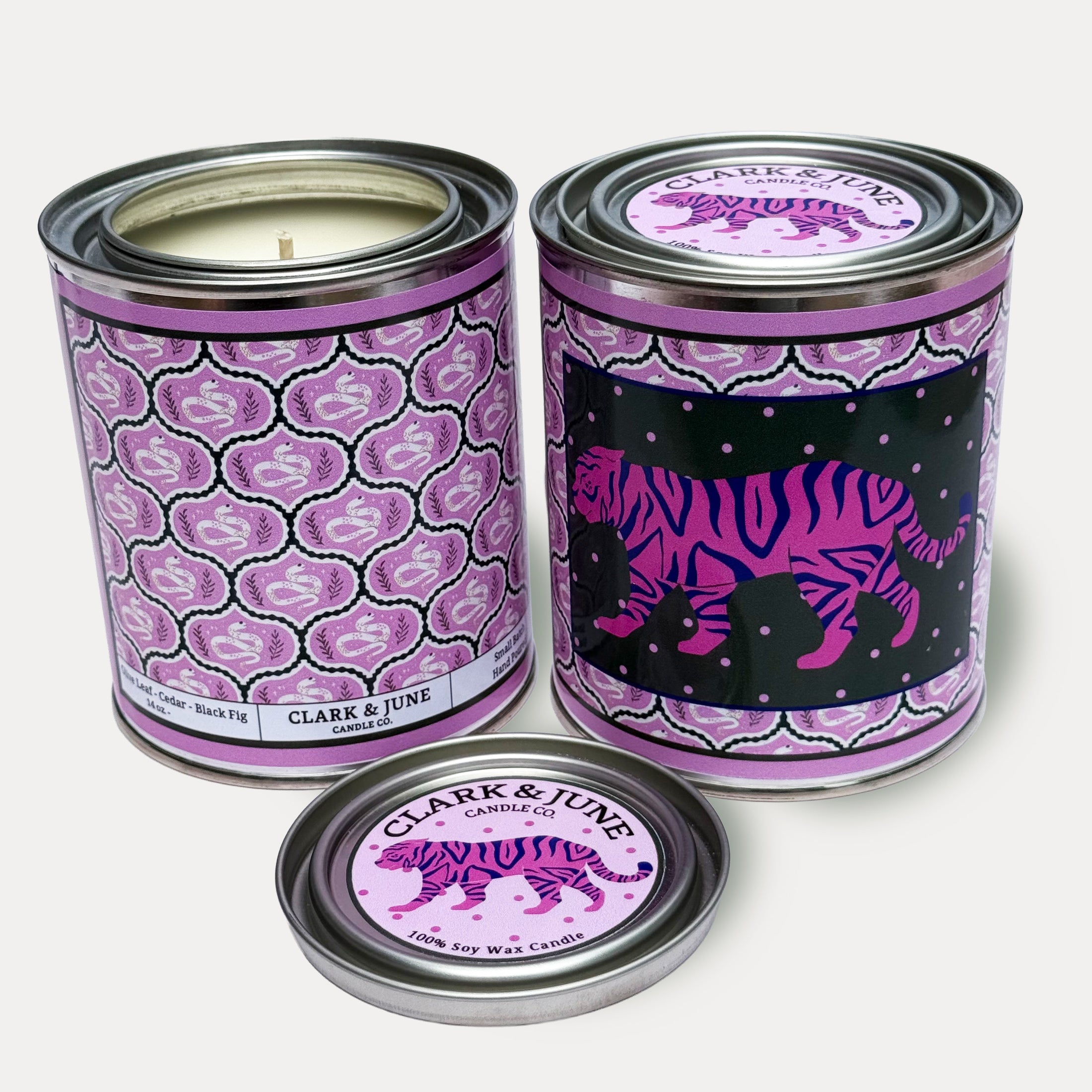 14oz Tiger design soy wax candle in a pint sized paint can made by Clark & June Candle Co. The candle is wrapped with a lavender  label showing a repeating design of snakes and leaves on the back and a prowling tiger front. The scent is Olive Leaf – Cedar – Black Fig and was hand poured in small batches. 
Tiger Candle, Scented Candle, Paint Can Candle. Single Cotton Wick
