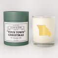 Load image into Gallery viewer, Double wicked soy candle in a 13.5 oz tumbler with the state of   Missouriprinted in 22k gold foil on the face. Green cylinder packaging with "Your Town" Christmas on the label. SEO Text – Drinking glass, soy wax candle, Christmas Candle, hand poured, small batch, scented candle, Woman Owned, local candle, Housewarming present, gives back, charity, community candle, becomes a cocktail glass, closing gift.