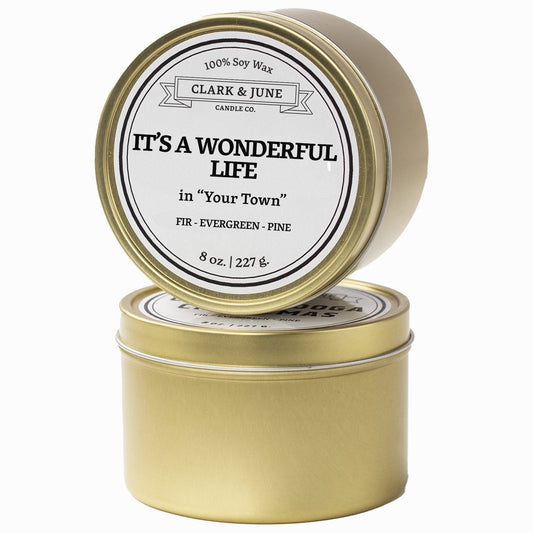 Single wicked Fir - Evergreen - Pine scented 8oz candle in gold finish with It's a Wonderful Life in "Your Town" on the label. SEO Text –soy wax candle, Christmas candle, Holiday candle hand poured, small batch, scented candle, Woman Owned, local candle, Housewarming present, gives back, charity, community candle, Soy wax candle Christmas gift.