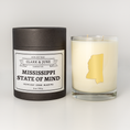 Load image into Gallery viewer, Double wicked soy candle in a 13.5 oz tumbler with the state of  Mississippi printed in 22k gold foil on the face. Black cylinder packaging with Mississippi State of Mind on the label. SEO Text â€“ Drinking glass, soy wax candle, Christmas Candle, hand poured, small batch, scented candle, Woman Owned, local candle, Housewarming present, gives back, charity, community candle, becomes a cocktail glass, closing gift. 

