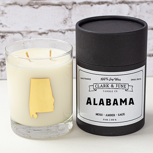 Double wicked soy candle in a 13.5 oz tumbler with the state of Alabama printed in 22k gold foil on the face. Black cylinder packaging with “Alabama” on the label. SEO Text – Drinking glass, soy wax candle, Alabama candle, hand poured, small batch, scented candle, Woman Owned, local candle, Housewarming present, gives back, charity, community candle, becomes a cocktail glass, closing gift. 