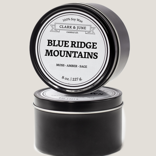 Single wicked 8oz candle in a black finish with Blue Ridge Mountains  on the label. SEO Text –soy wax candle, Virginia candle, hand poured, small batch, scented candle, Woman Owned, local candle, Housewarming present, gives back, charity, community candle, closing gift. 
