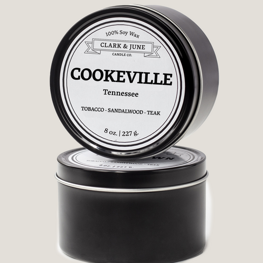 Single wicked 8oz candle in a black finish with Cookeville  on the label. SEO Text –soy wax candle, Tennessee candle, hand poured, small batch, scented candle, Woman Owned, local candle, Housewarming present, gives back, charity, community candle, closing gift. 
