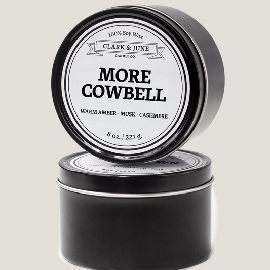 Single wicked 8oz candle in a black finish with More Cowbell on the label. SEO Text –soy wax candle, Mississippi candle, hand poured, small batch, scented candle, Woman Owned, local candle, Housewarming present, gives back, charity, community candle, closing gift. 
