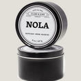 Load image into Gallery viewer, Single wicked 8oz candle in a black finish with NOLA  on the label. SEO Text –soy wax candle, Louisiana candle, hand poured, small batch, scented candle, Woman Owned, local candle, Housewarming present, gives back, charity, community candle, closing gift. 

