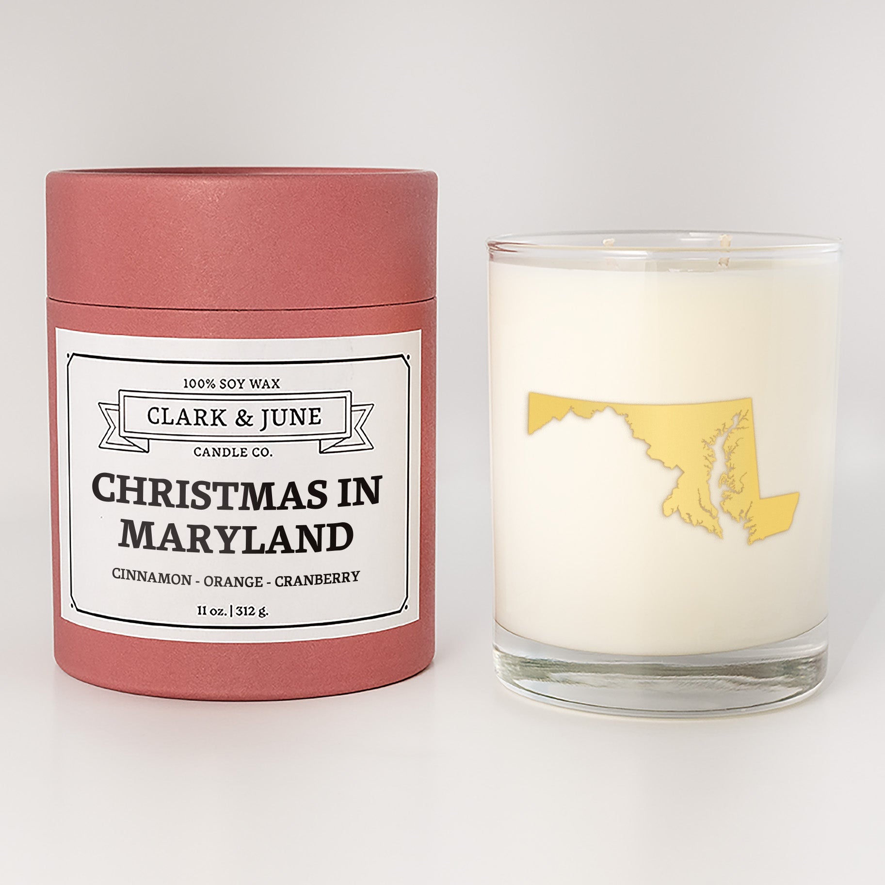 Double wicked soy candle in a 13.5 oz tumbler with the state of  Maryland printed in 22k gold foil on the face. Red cylinder packaging with Christmas in Maryland on the label. SEO Text â€“ Drinking glass, soy wax candle, Christmas Candle, hand poured, small batch, scented candle, Woman Owned, local candle, Housewarming present, gives back, charity, community candle, becomes a cocktail glass, closing gift. 
