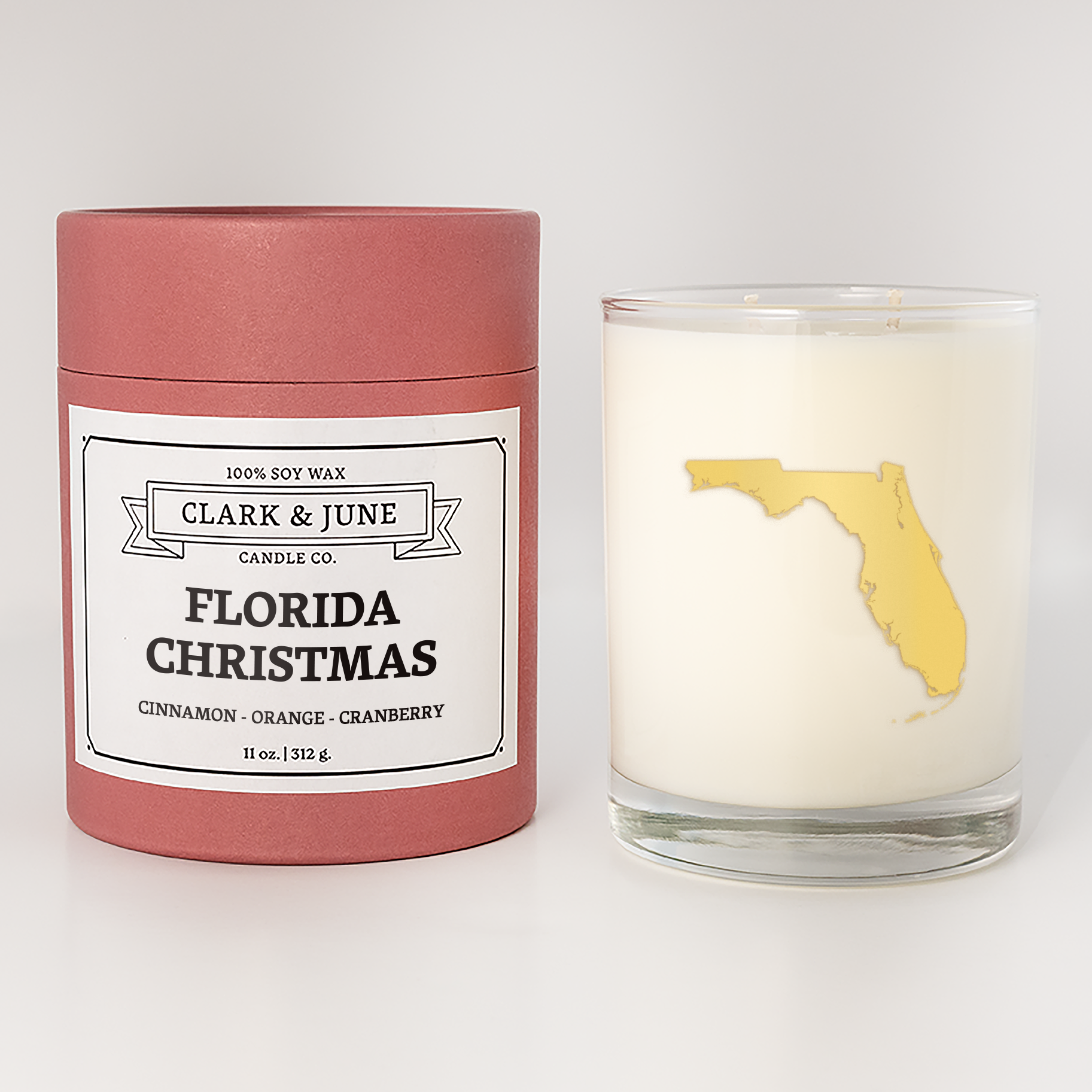 Double wicked soy candle in a 13.5 oz tumbler with the state of  Florida printed in 22k gold foil on the face. Red cylinder packaging with Florida Christmas on the label. SEO Text â€“ Drinking glass, soy wax candle, Christmas Candle, hand poured, small batch, scented candle, Woman Owned, local candle, Housewarming present, gives back, charity, community candle, becomes a cocktail glass, closing gift. 
