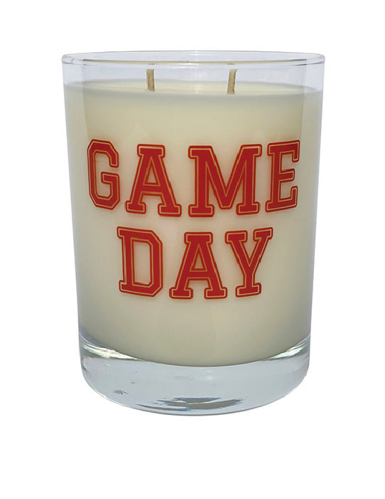 Double wicked soy candle in a 13.5 oz tumbler with the Game Day printed on the face of the vessel in Red. SEO Text – Drinking glass, soy wax candle, Football, Tailgate, hand poured, small batch, scented candle, Woman Owned, local candle, Housewarming present, gives back, charity, community candle, becomes a cocktail glass, closing gift. 