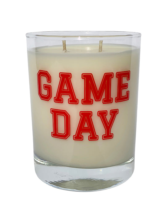 Double wicked soy candle in a 13.5 oz tumbler with the Game Day printed on the face of the vessel in Red. SEO Text – Drinking glass, soy wax candle, Football, Tailgate, hand poured, small batch, scented candle, Woman Owned, local candle, Housewarming present, gives back, charity, community candle, becomes a cocktail glass, closing gift. 