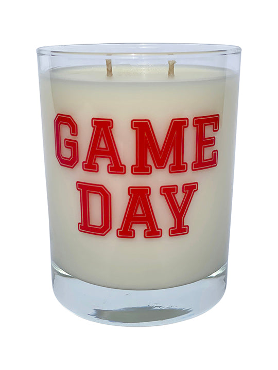 Double wicked soy candle in a 13.5 oz tumbler with the Game Day printed on the face of the vessel in Red. SEO Text – Drinking glass, soy wax candle, Football, Tailgate, hand poured, small batch, scented candle, Woman Owned, local candle, Housewarming present, gives back, charity, community candle, becomes a cocktail glass, closing gift. 