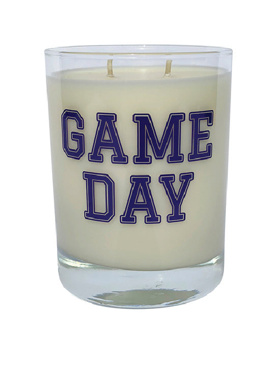 Double wicked soy candle in a 13.5 oz tumbler with the Game Day printed on the face of the vessel in Purple. SEO Text – Drinking glass, soy wax candle, Football, Tailgate, hand poured, small batch, scented candle, Woman Owned, local candle, Housewarming present, gives back, charity, community candle, becomes a cocktail glass, closing gift. 