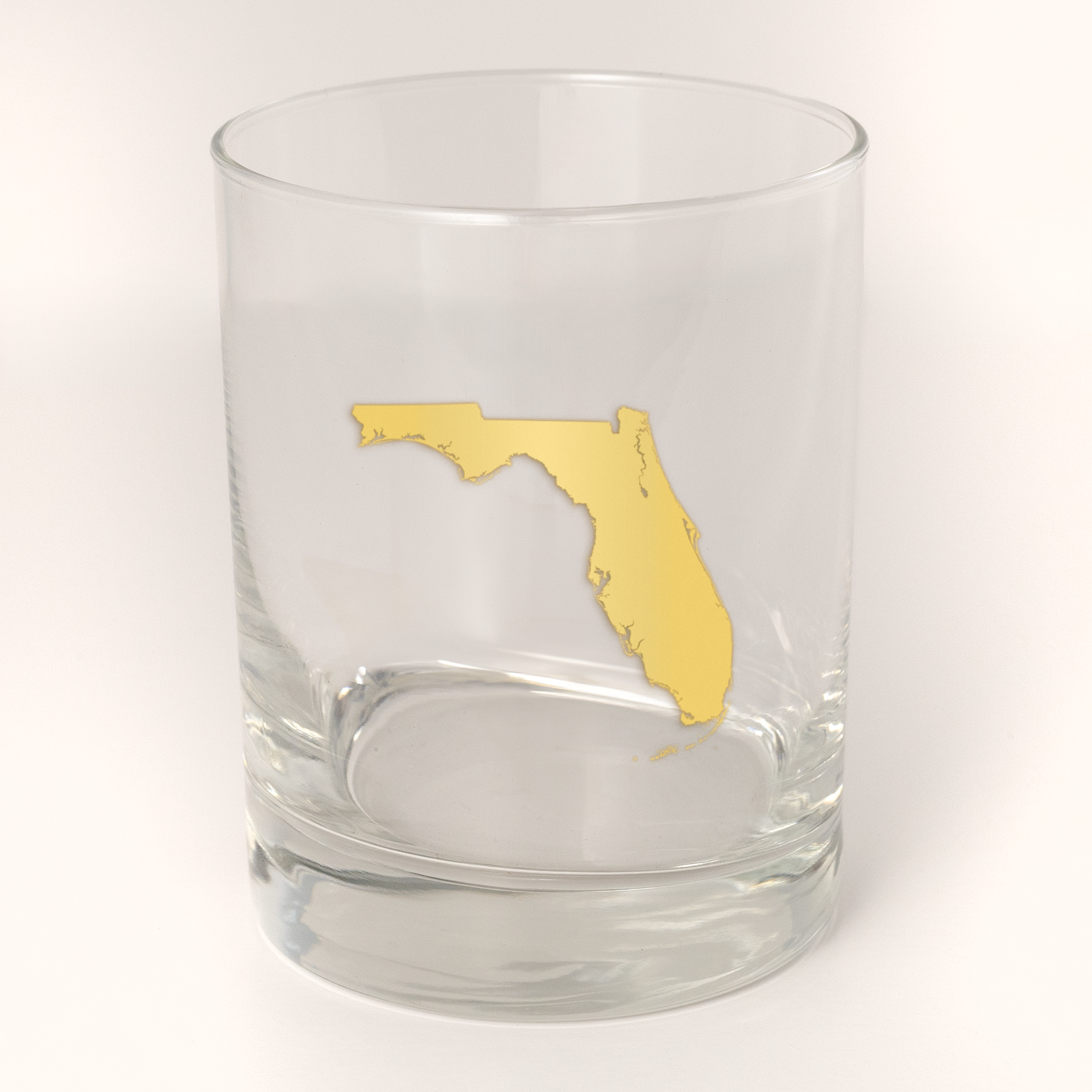 13.5oz Old Fashioned Rocks Glass with the state of Florida silhouetted in 22k gold foil on the face.  Drinking Glass