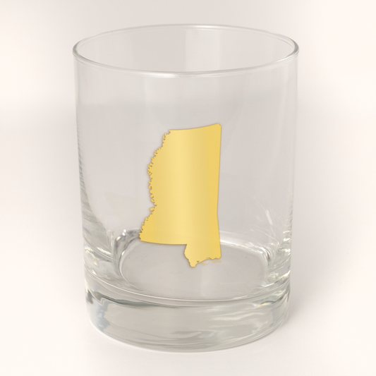 13.5oz Old Fashioned Rocks Glass with the state of Mississippi silhouetted in 22k gold foil on the face.  Drinking Glass