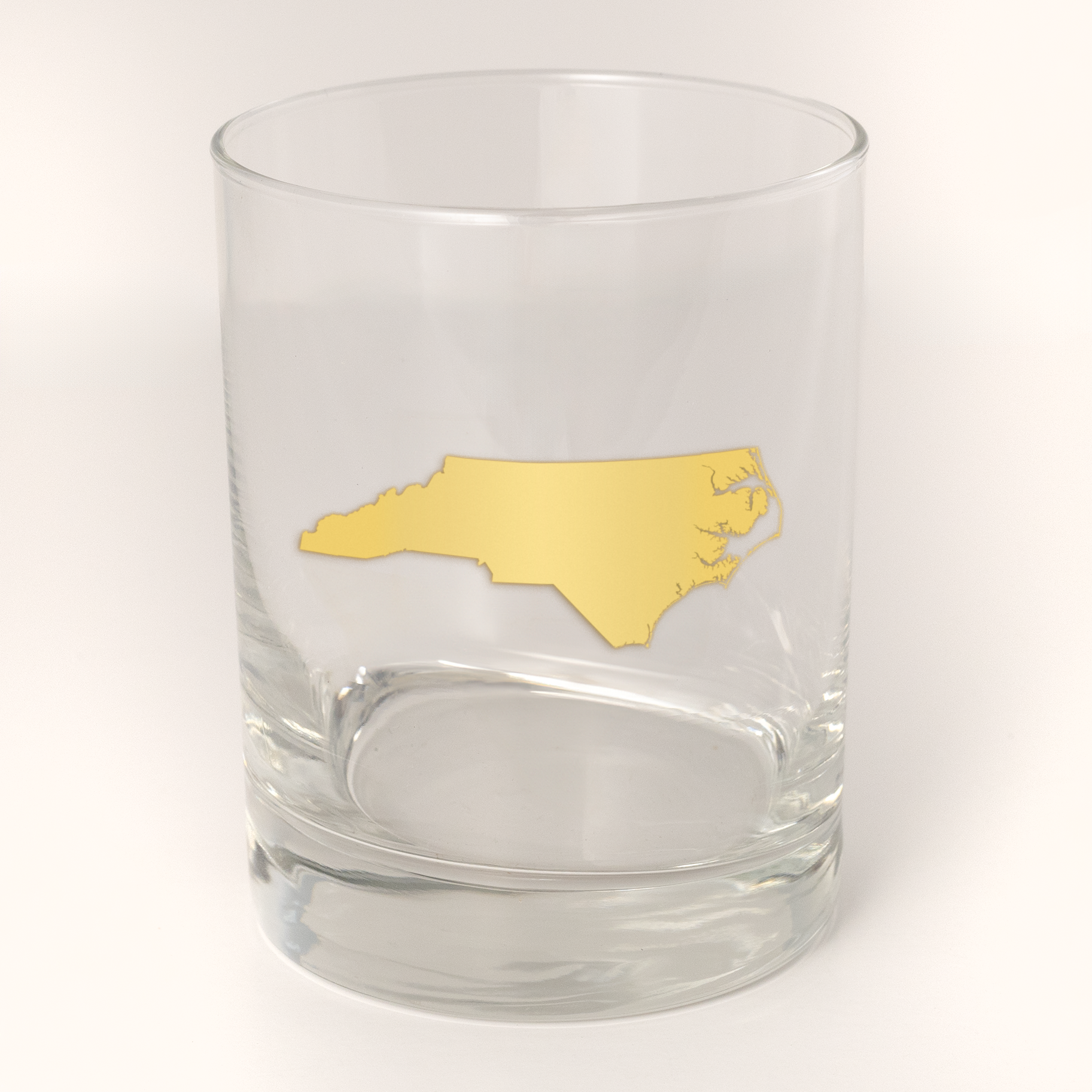 13.5oz Old Fashioned Rocks Glass with the state of North Carolina silhouetted in 22k gold foil on the face. Drinking Glass