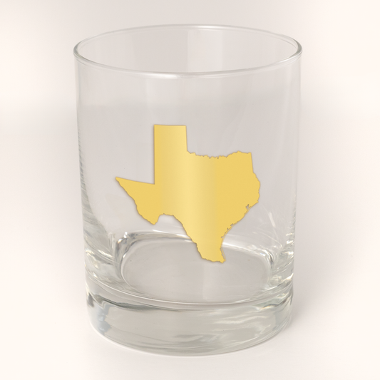 13.5oz Old Fashioned Rocks Glass with the state of Texas silhouetted in 22k gold foil on the face.  Drinking Glass