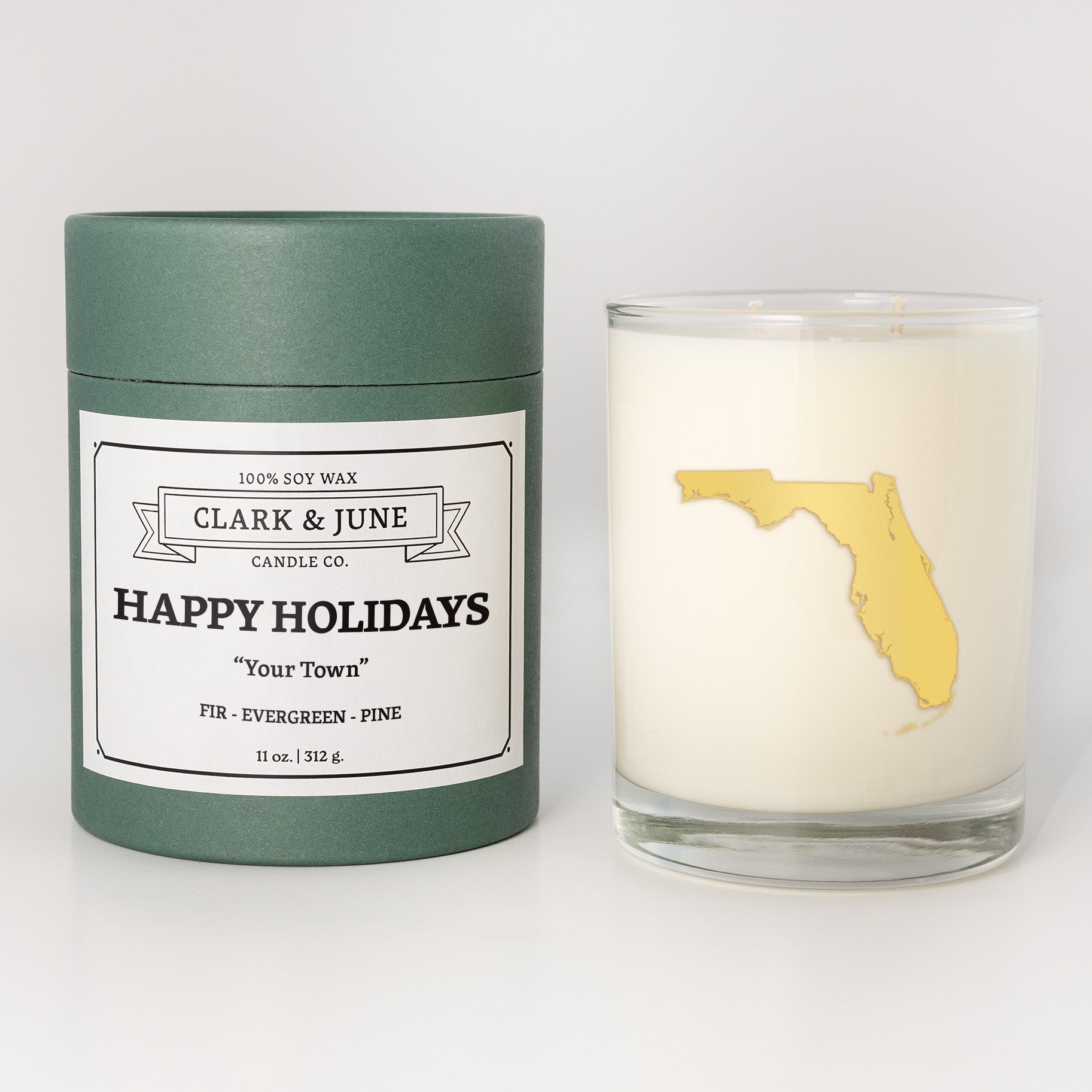 Double wicked soy candle in a 13.5 oz tumbler with the state of   Florida printed in 22k gold foil on the face. Green cylinder packaging with Happy Holidays in "Your Town" on the label. SEO Text â€“ Drinking glass, soy wax candle, Christmas Candle, hand poured, small batch, scented candle, Woman Owned, local candle, Housewarming present, gives back, charity, community candle, becomes a cocktail glass, closing gift. 
