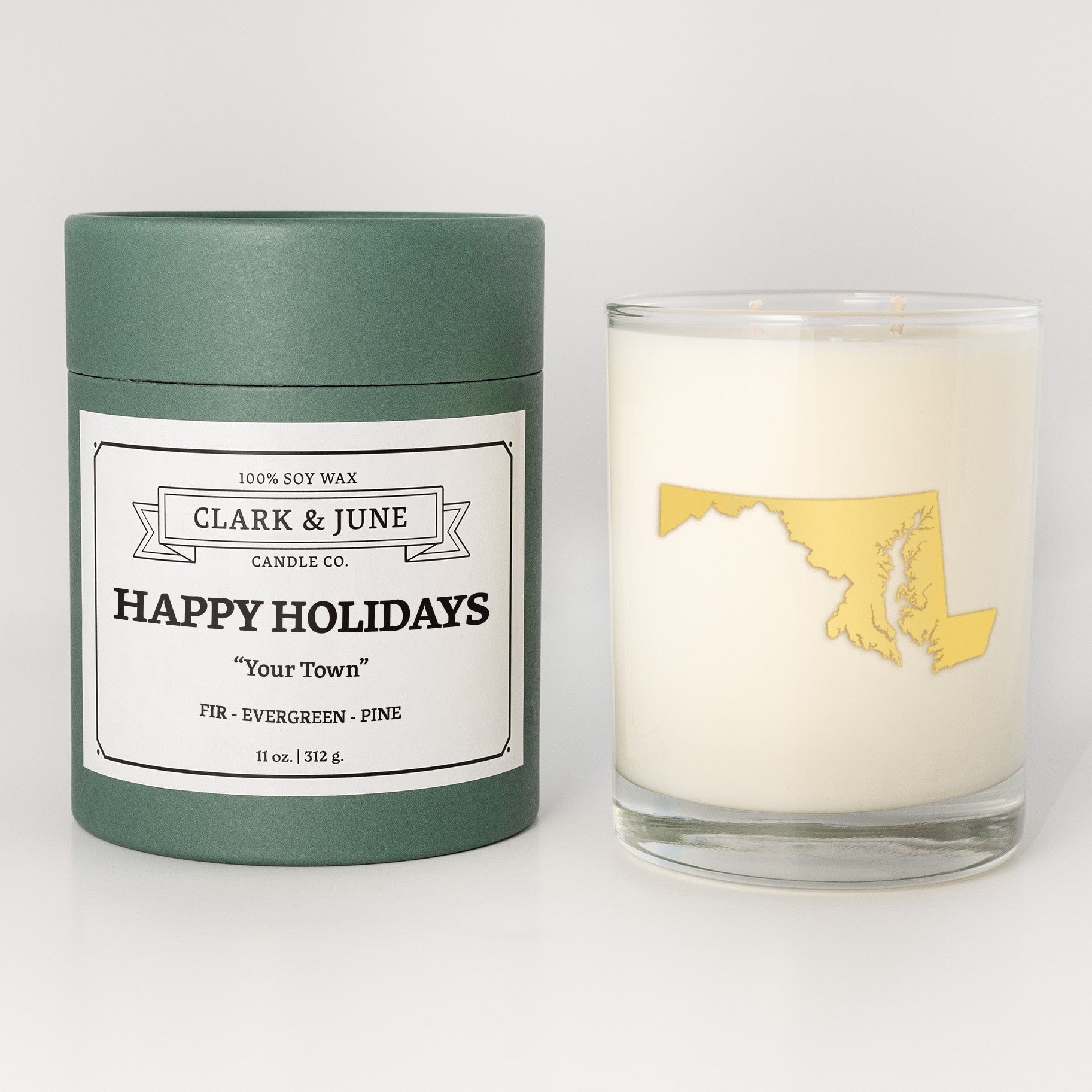 Double wicked soy candle in a 13.5 oz tumbler with the state of   Maryland printed in 22k gold foil on the face. Green cylinder packaging with Happy Holidays in "Your Town" on the label. SEO Text â€“ Drinking glass, soy wax candle, Christmas Candle, hand poured, small batch, scented candle, Woman Owned, local candle, Housewarming present, gives back, charity, community candle, becomes a cocktail glass, closing gift. 
