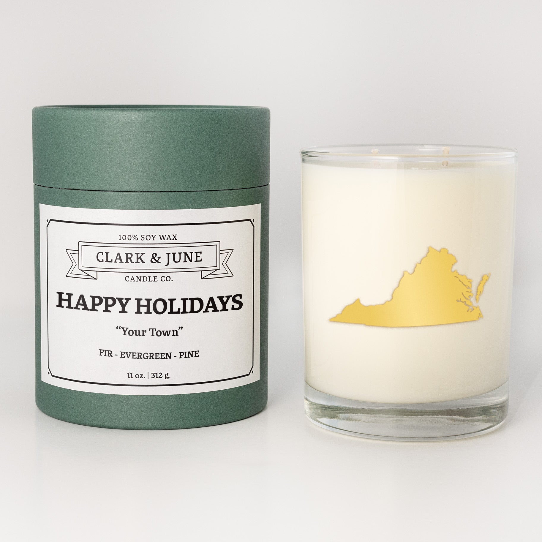 Double wicked soy candle in a 13.5 oz tumbler with the state of   Virginia printed in 22k gold foil on the face. Green cylinder packaging with Happy Holidays in "Your Town" on the label. SEO Text â€“ Drinking glass, soy wax candle, Christmas Candle, hand poured, small batch, scented candle, Woman Owned, local candle, Housewarming present, gives back, charity, community candle, becomes a cocktail glass, closing gift. 
