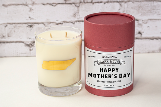Double wicked soy candle in a 13.5 oz tumbler with the state of Tennessee printed in 22k gold foil on the face. Red cylinder packaging with “Happy Mother’s Day” on the label. 