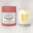 Load image into Gallery viewer, Double wicked soy candle in a 13.5 oz tumbler with the state of  Arkansas printed in 22k gold foil on the face. Red cylinder packaging with Home for the Holidays on the label. SEO Text â€“ Drinking glass, soy wax candle, Christmas Candle, hand poured, small batch, scented candle, Woman Owned, local candle, Housewarming present, gives back, charity, community candle, becomes a cocktail glass, closing gift. 

