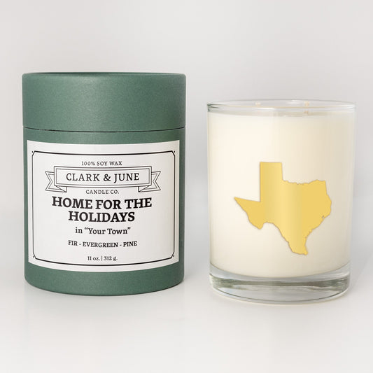 Double wicked soy candle in a 13.5 oz tumbler with the state of Texasprinted in 22k gold foil on the face. Green cylinder packaging with Home for the Holidays in "Your Town"on the label. SEO Text – Drinking glass, soy wax candle, Christmas Candle, hand poured, small batch, scented candle, Woman Owned, local candle, Housewarming present, gives back, charity, community candle, becomes a cocktail glass, closing gift. 